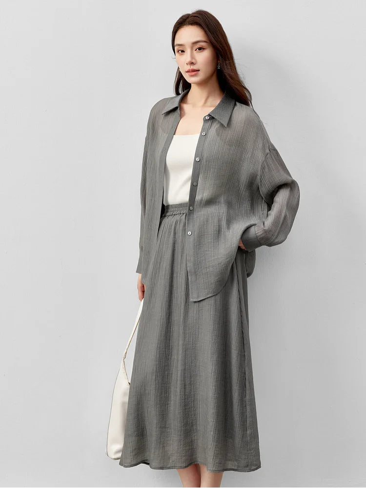 A woman in an unfastened graphite rain lyocell shirt with a hand on her hip. — From Borcelleclothes.