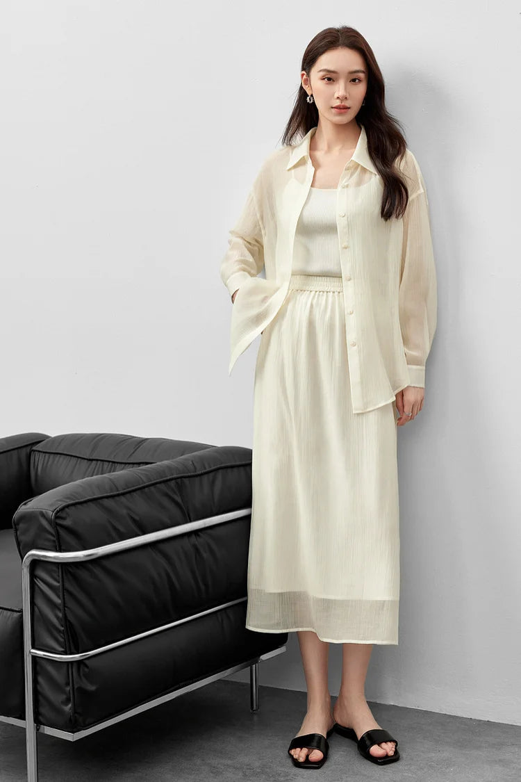 A woman leaning against a wall in a semi-sheer pollen flight lyocell two-piece set. — From Borcelleclothes.