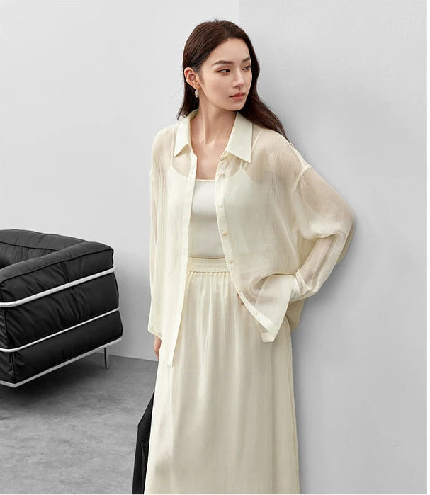 A woman in an unfastened pollen flight lyocell shirt looking to the side with a hand on her hip. — From Borcelleclothes.