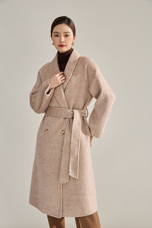 A tactile moment with the soft shawl collar of the double-sided lambswool coat in Mustique shade. From Borcelleclothes.