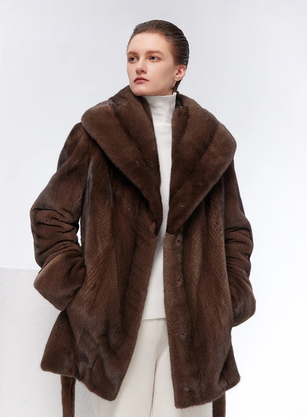 Model with both hands in pockets wearing Eclipse shawl-collared mink coat — From Borcelleclothes.