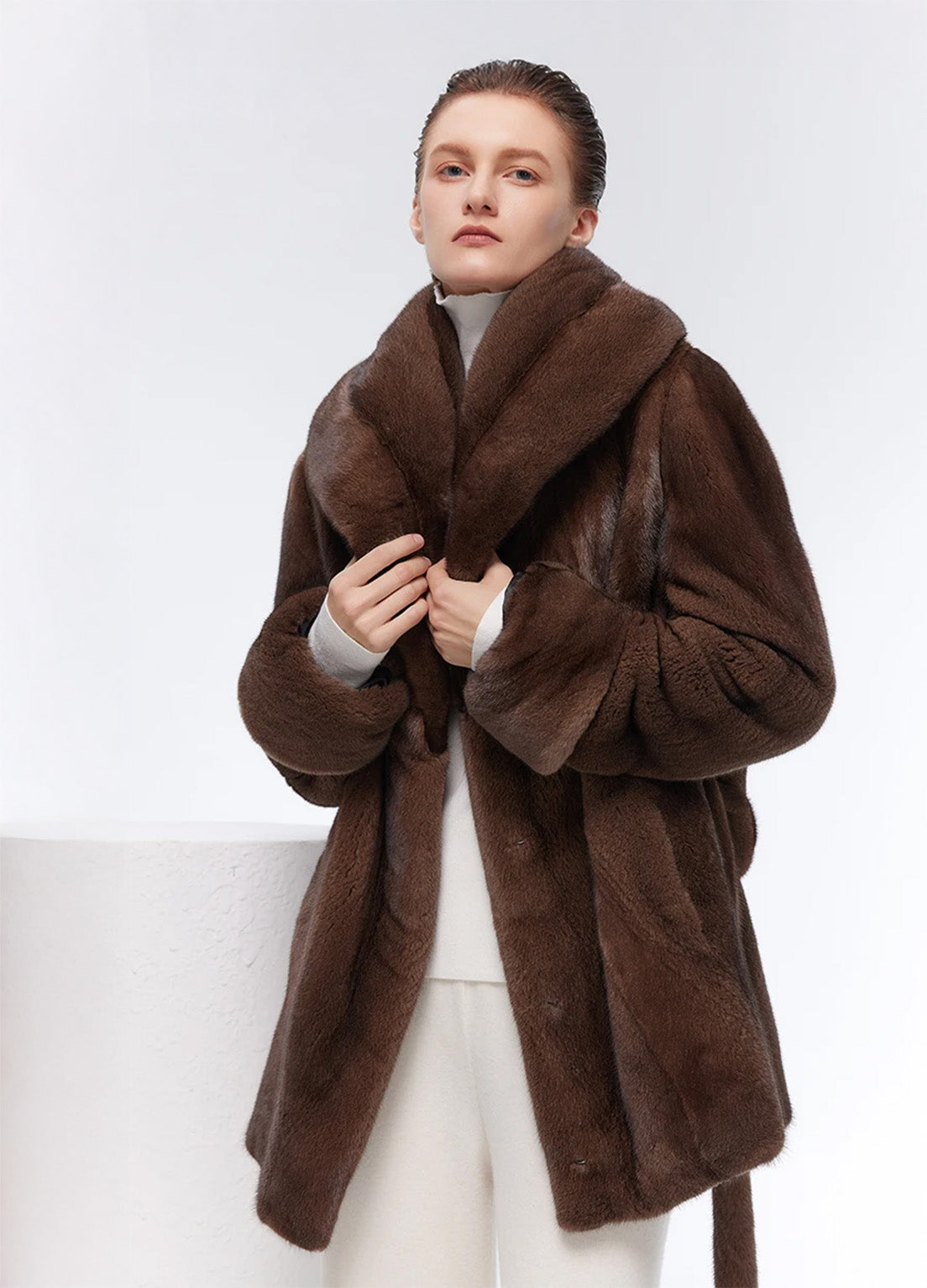 Model holding shawl collar of Eclipse sheared mink coat — From Borcelleclothes.