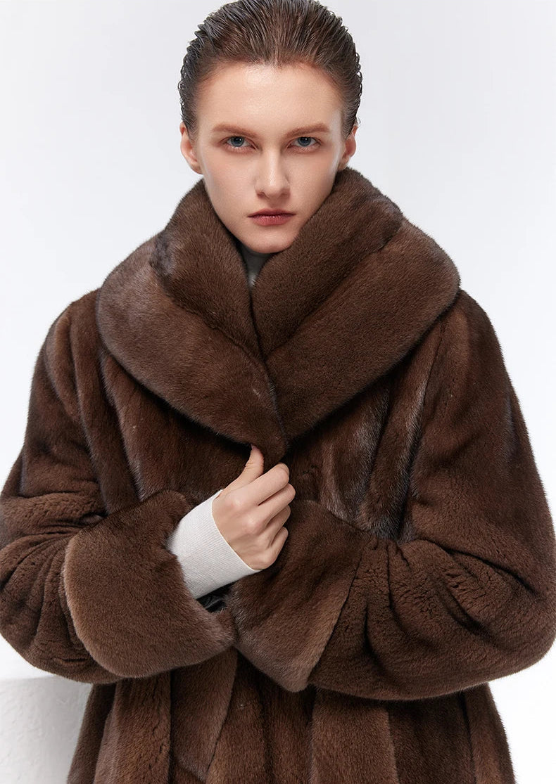 Model wrapping unfastened Eclipse mink coat with wide shawl collar — From Borcelleclothes.