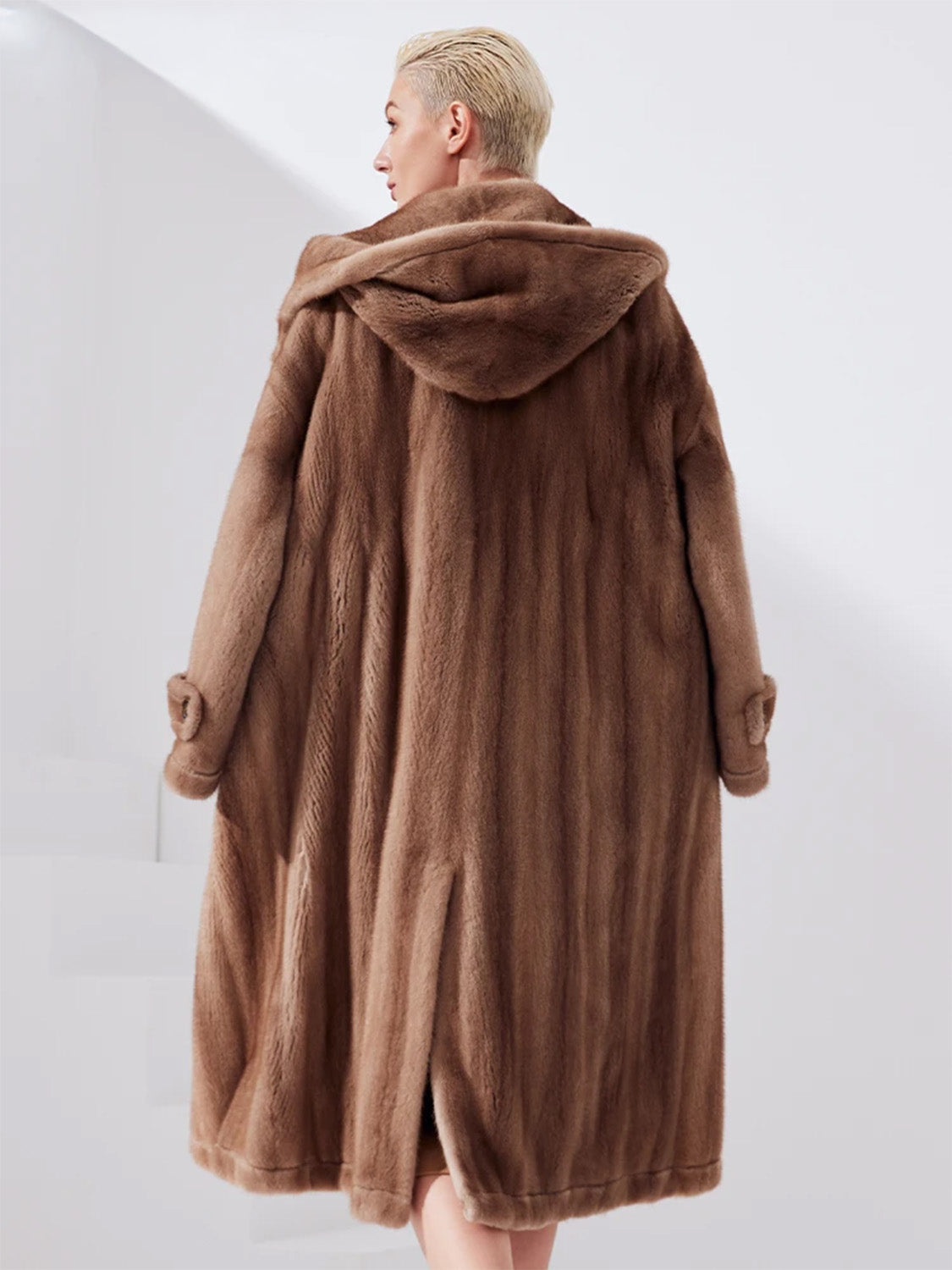 Back view of a women's sheared mink coat in Dreamcatcher color showing flared silhouette and back vent — From Borcelleclothes.