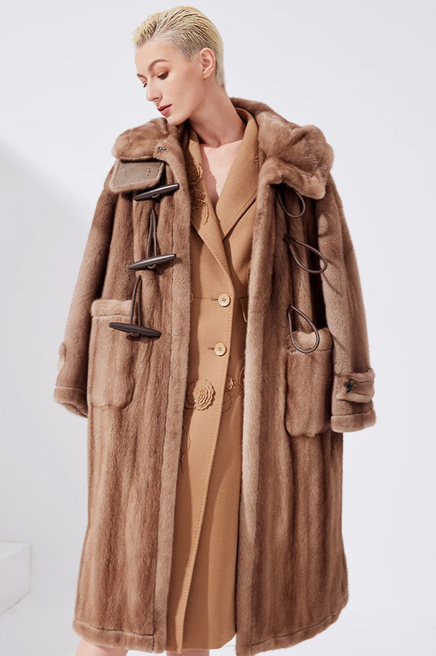 Model wearing the sheared mink coat in Dreamcatcher color draped over shoulders, without arms in sleeves — From Borcelleclothes.