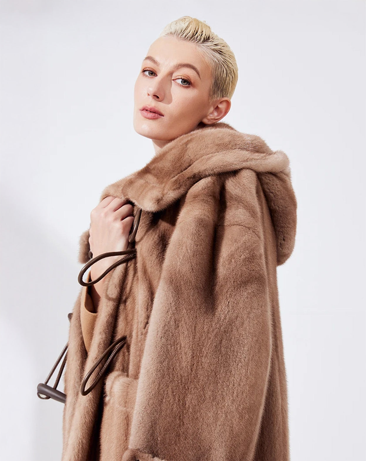 Upper part of a women's sheared mink coat in Dreamcatcher color, model with visible collar and no hood, looking ahead — From Borcelleclothes.