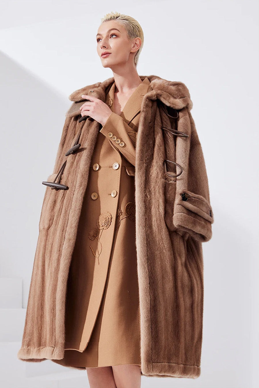 Women’s sheared mink coat in Dreamcatcher color with a flared silhouette, generous hood, leather toggle details, and a mid-calf length — From Borcelleclothes.