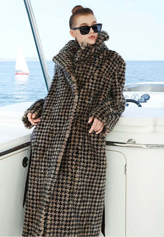 Sheared mink coat in Blonde Shell houndstooth. Model leans on yacht helm console, showcasing sculpted collar and relaxed silhouette. — From Borcelleclothes.