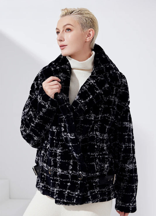 Model wearing sheared mink jacket in Jaguar, touching sculptural lapel — From Borcelleclothes.