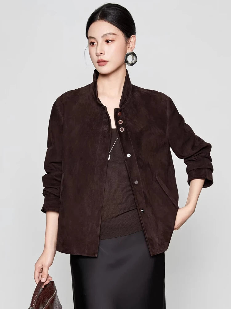 Styled full view of the Comfortable Wenge suede jacket as the model holds a bag while adjusting the jacket hemline — From Borcelleclothes.