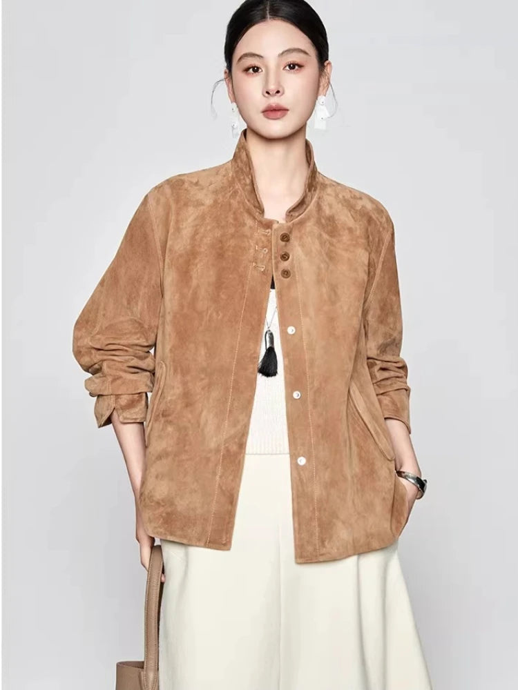 Model styled in the Moiré Trace sheepskin suede jacket with accent buttons, holding a structured beige bag — From Borcelleclothes.