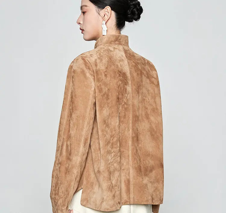Three-quarter rear view of the model wearing the Moiré Trace suede jacket, looking over her shoulder to show the collar line and fit — From Borcelleclothes.