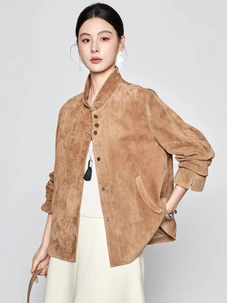 Side-angle view of the Moiré Trace suede jacket with the model turned towards the camera, showcasing the hip-length cut and split cuffs — From Borcelleclothes.