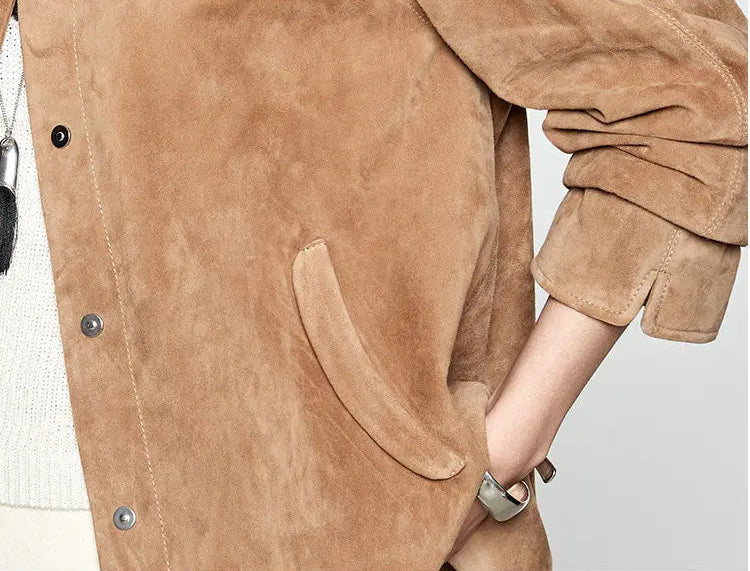 Detailed macro view of the powder-soft suede nap, diagonally placed pocket with curved welt, and sleeve split cuff — From Borcelleclothes.