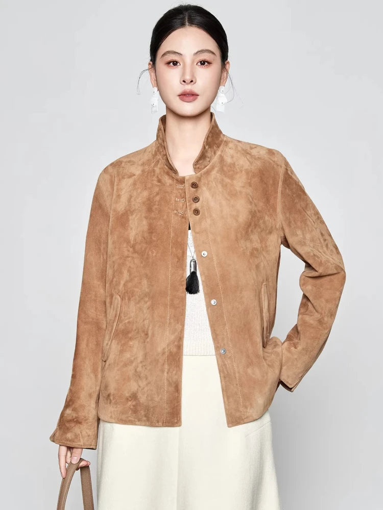 Front view of an unfastened Moiré Trace suede jacket, showing the straight drape with the model gently lifting the side hem — From Borcelleclothes.