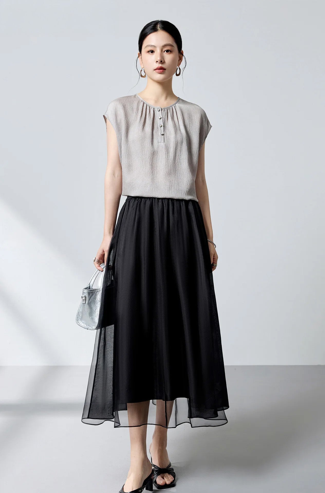 Full-length shot of model wearing the Where Lives Nacre silk georgette blouse with dropped cap sleeves. — From Borcelleclothes.