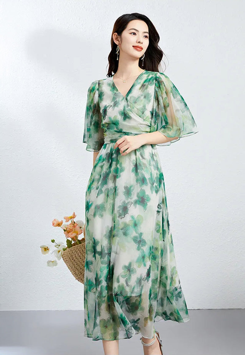 A woman in motion looking aside, wearing a translucent Jade Breeze silk georgette dress that flows like a misty jade vision — From Borcelleclothes.
