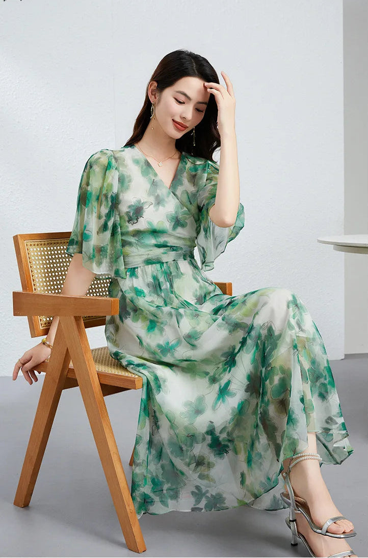 A woman in a Jade Breeze silk georgette dress adjusting her hair, revealing the ethereal flutter sleeves and high-waist silhouette — From Borcelleclothes.