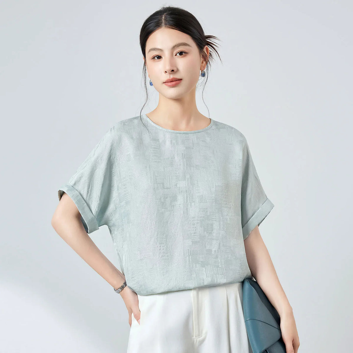 Women's 19 momme Mulberry silk Sangbo jacquard blouse with light-reflective flecks in Glacial Spring. Features short kimono sleeves, turned-back cuffs, and a cat's-eye button closure. — Froom Borcelleclothes.