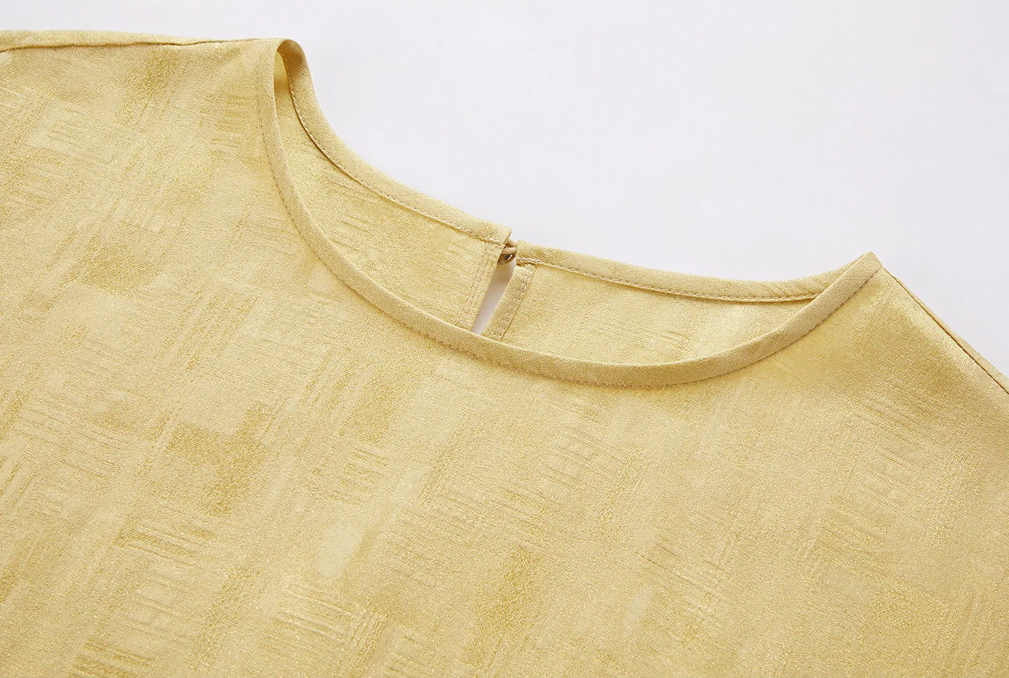 Detailed close-up of the clean-finished neckline and rich Sangbo jacquard weave on a Hakea silk blouse — From Borcelleclothes.