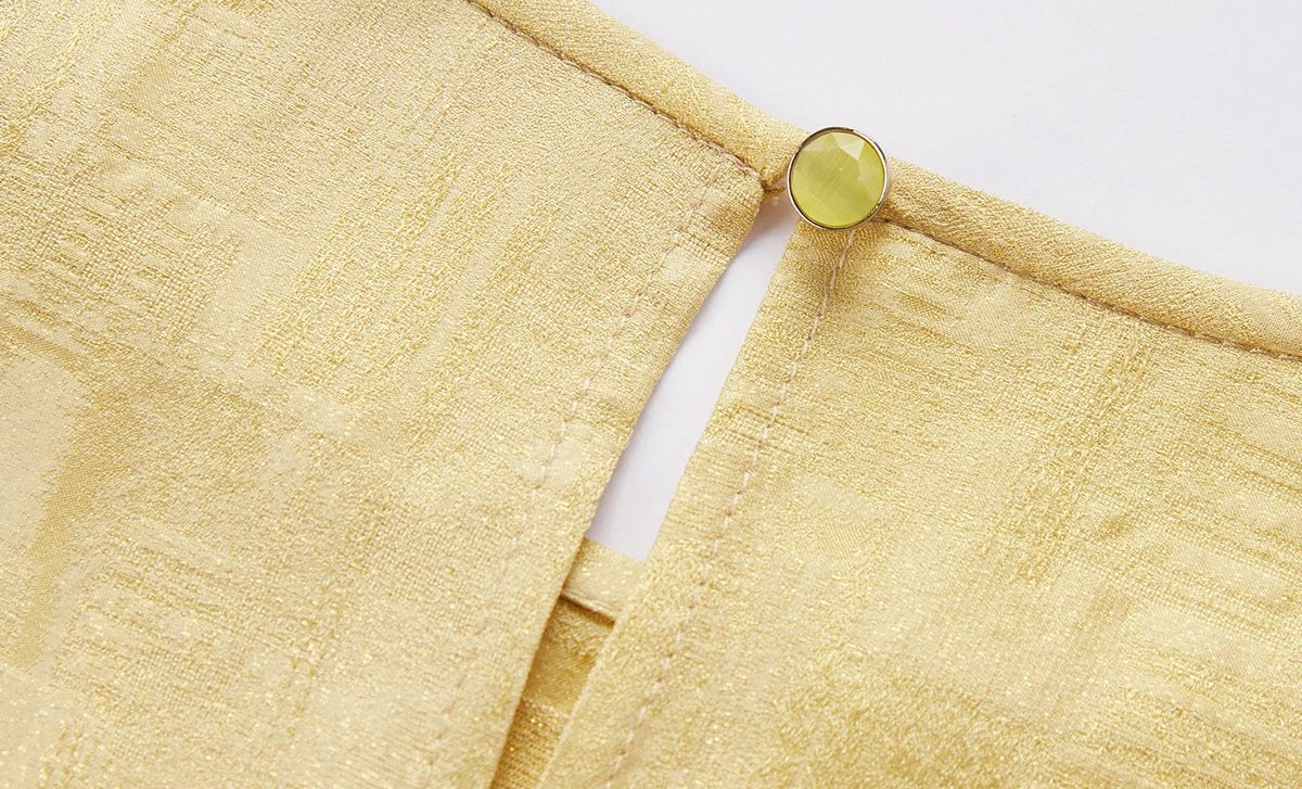 Detail view of the delicate back slit closure and button fastening on a Hakea silk Sangbo blouse — From Borcelleclothes.