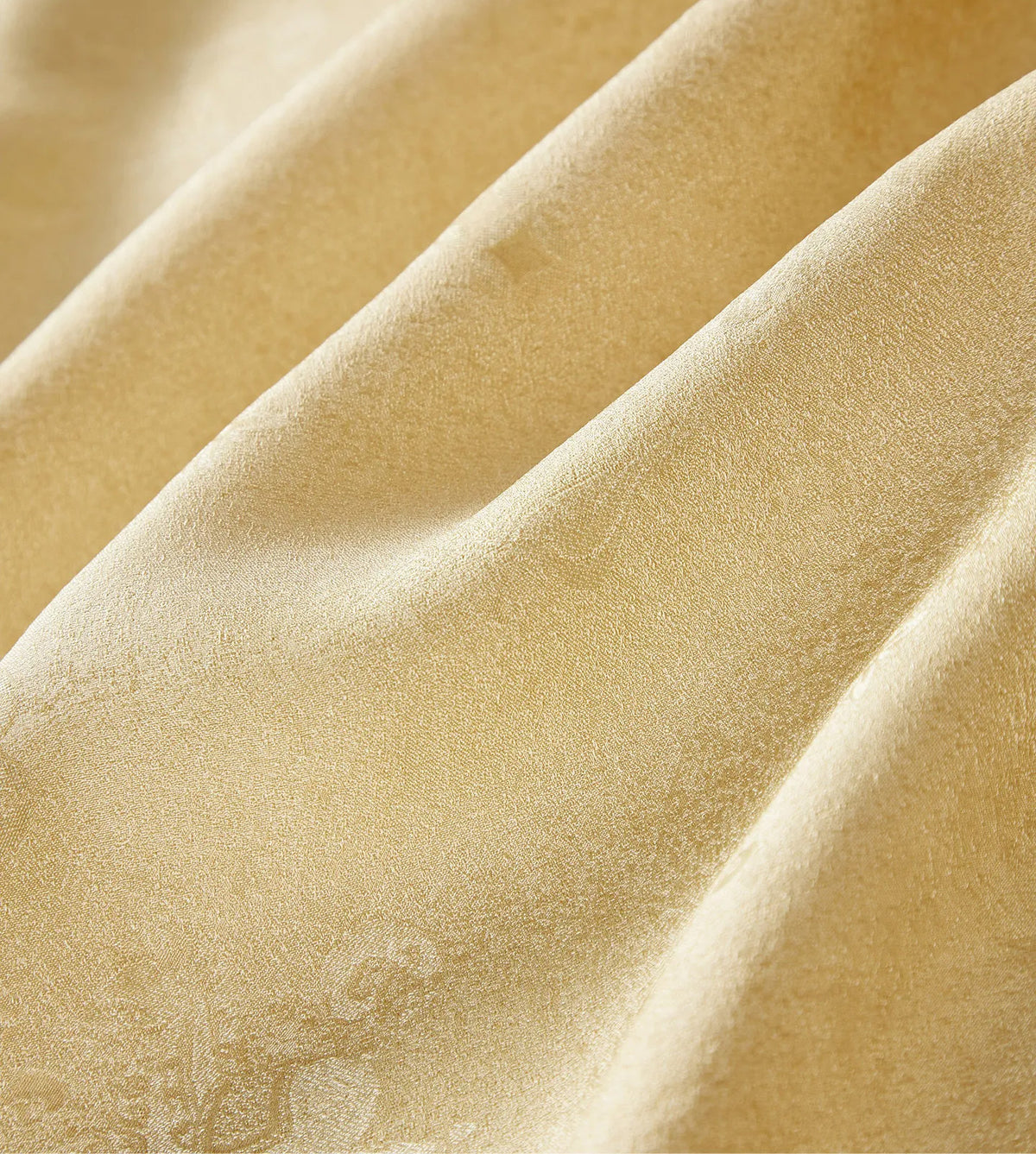 Macro close-up of folded Mulberry silk Sangbo jacquard fabric in Hakea showing raised wave texture and subtle metallic shimmer — From Borcelleclothes.