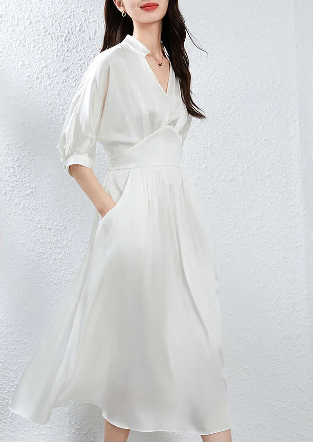 The dynamic flow of the Hot Ice silk dress as the woman moves, hand in pocket — From Borcelleclothes.