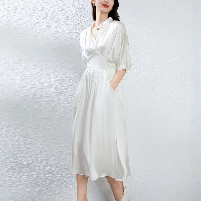 A midi-length Mulberry silk satin dress in Hot Ice, with a stand-up collar, V-neckline, and elegant pleated waist detail. — From Borcelleclothes.
