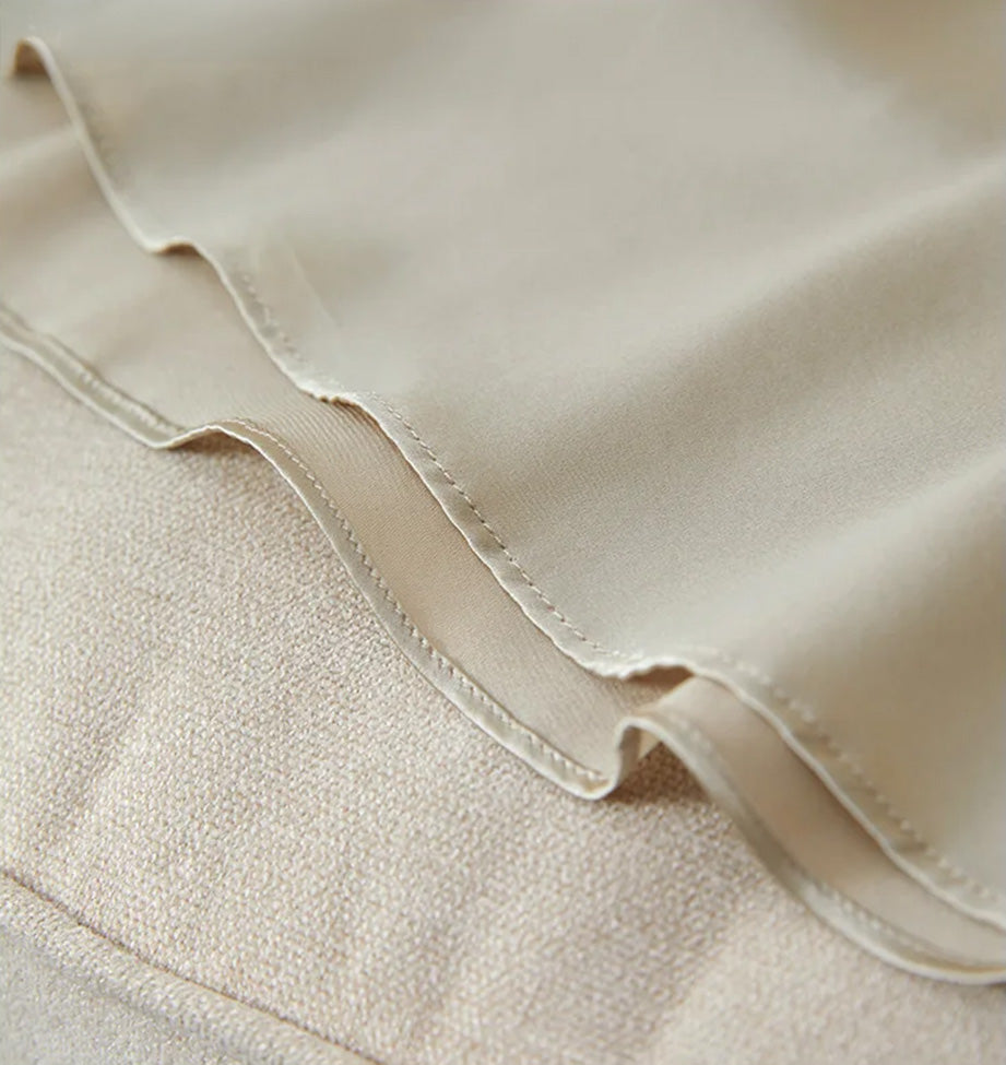 Precise stitching and clean finish of the bottom hem on the silk midi dress — From Borcelleclothes.
