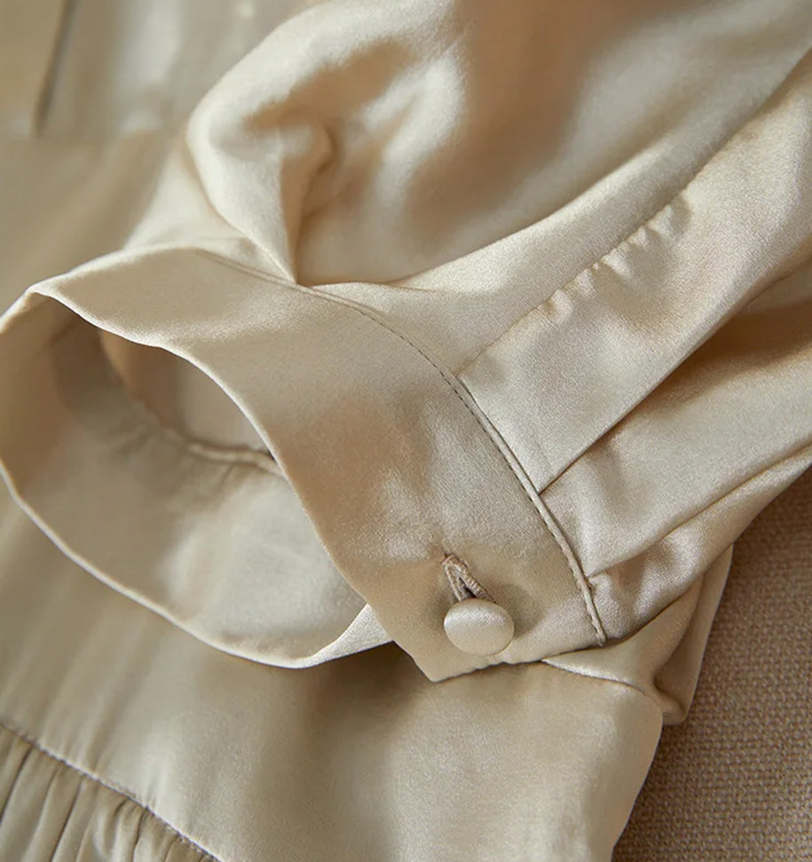 Silk-covered button closure on the elegant cuff of the batwing sleeve — From Borcelleclothes.