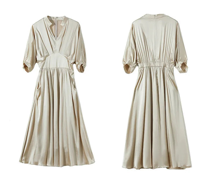 Flat lay of the silk satin dress showing the intricate front waist yoke and back design — From Borcelleclothes.
