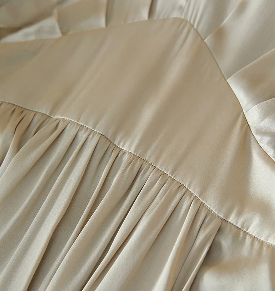 Close-up of the architectural oval waist yoke and integrated front pleats — From Borcelleclothes.