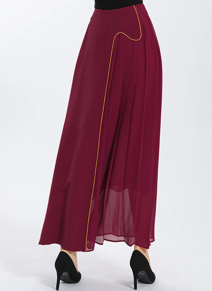 Back view of the asymmetric Carat Garnet silk maxi skirt on model, highlighting clean-finished waist darts and the elegant flow of heavy Mulberry silk — From Borcelleclothes.