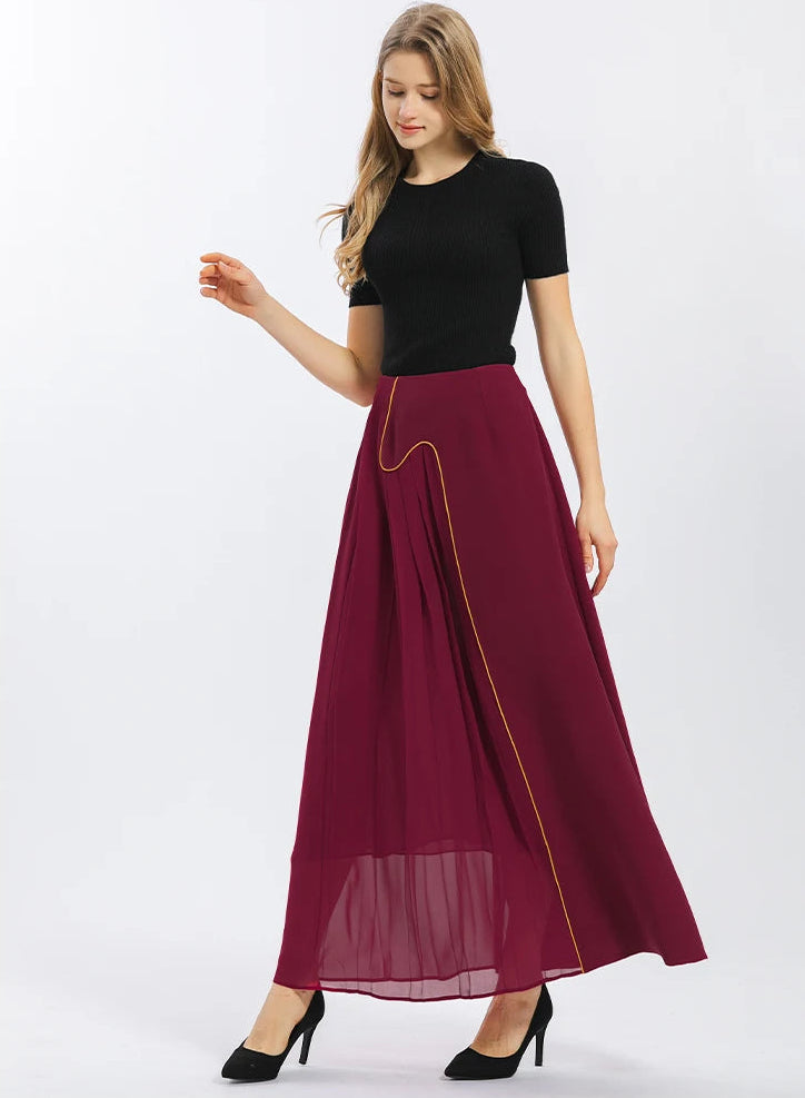 Silhouette of the Carat Garnet silk skirt in motion on model, showcasing the dynamic contrast between heavy crepe and flying pleated georgette — From Borcelleclothes.