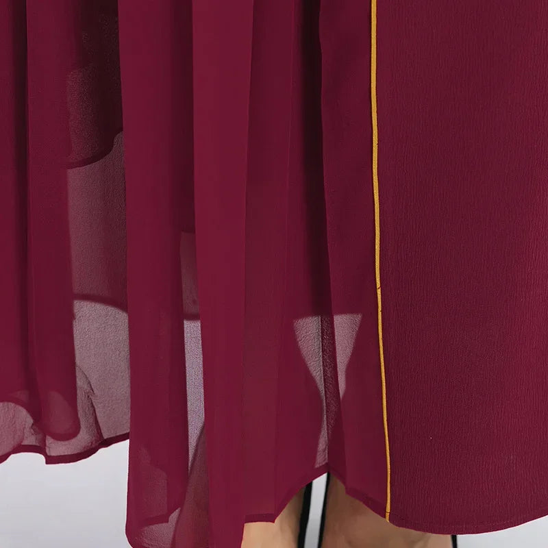 Detailed view of the skirt hem, focusing on the pressed parallel pleats of the semi-sheer Mulberry silk georgette — From Borcelleclothes.