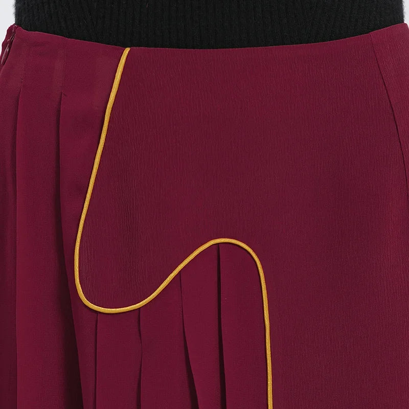 Close-up of the front waist section on the Carat Garnet silk skirt, showing the clean-finish internal facing, waist darts, and decorative curved upper edge — From Borcelleclothes.