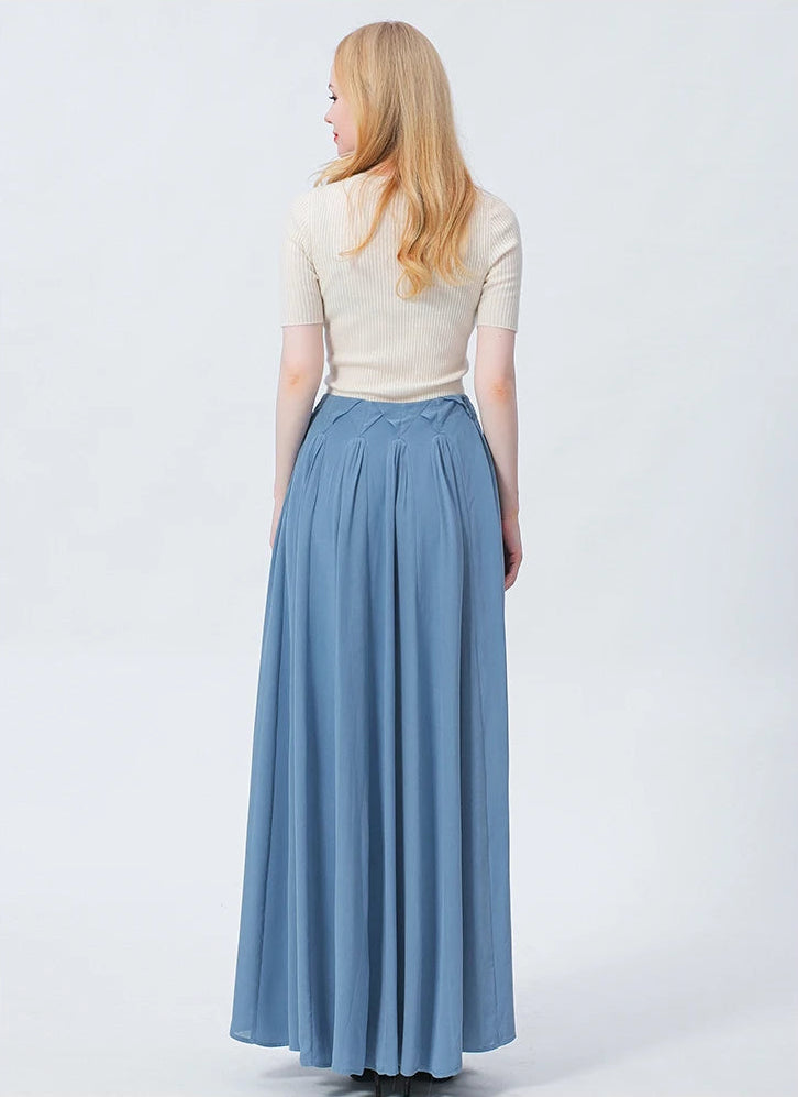 Full-height back view of a model in the ankle-length 'Wandering River' silk skirt, highlighting the majestic, flowing volume and structured, elongated lines of the avant-garde design. — From Borcelleclothes.