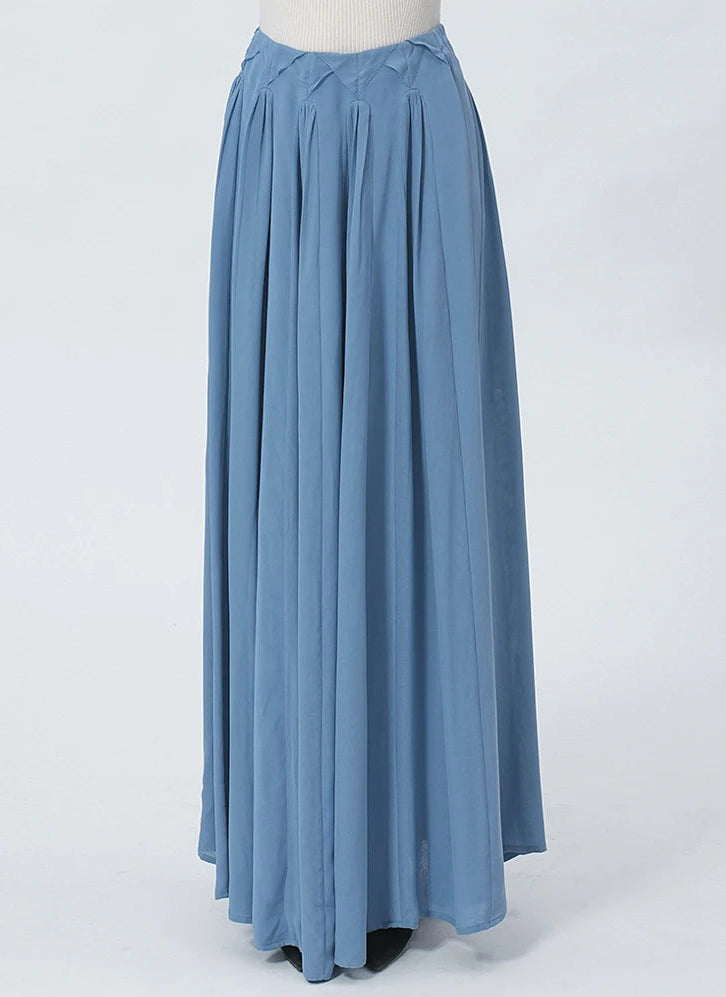 Front view of a model wearing the 6A Grade Mulberry Silk maxi skirt, emphasizing the clean, bulk-free hang of the fabric and the striking geometric layout from the waist down. — From Borcelleclothes.