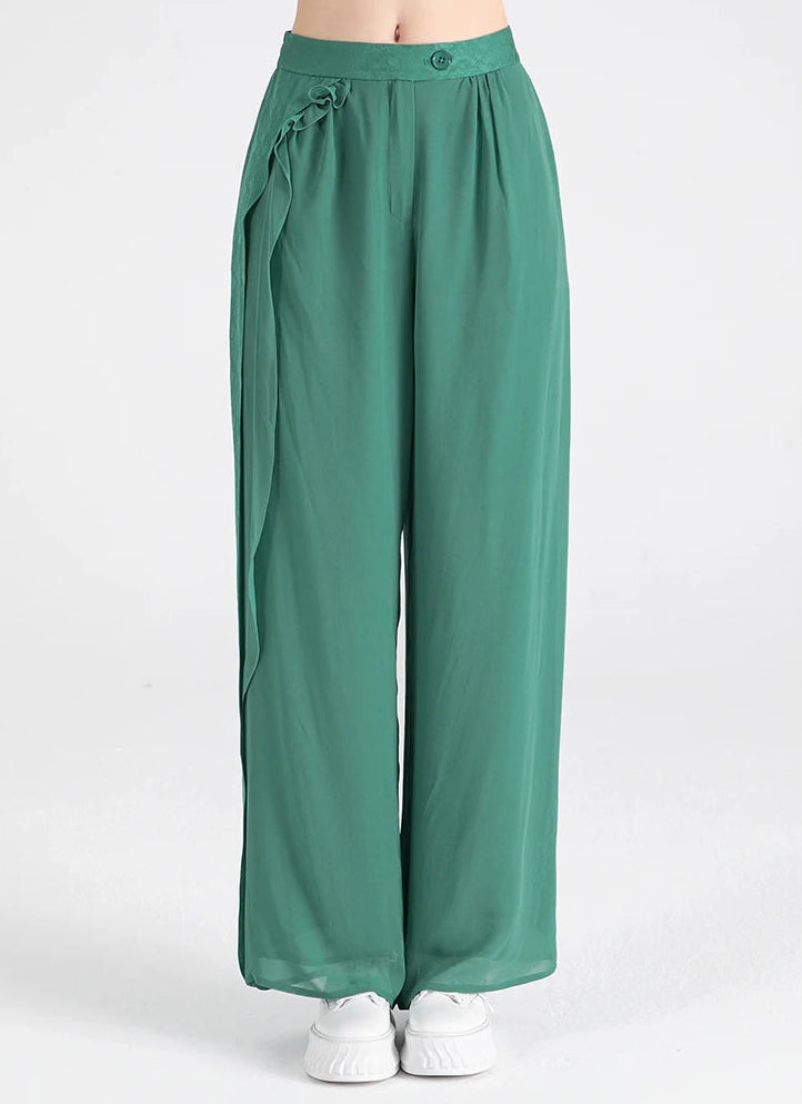 Front view of women's Calm Jade Mulberry silk wide-leg trousers featuring an asymmetrical jacquard overlay — From Borcelleclothes.