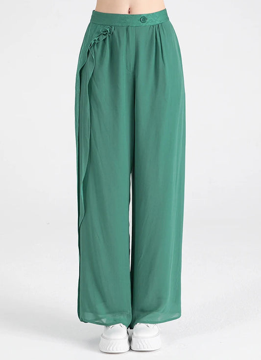 Front view of women's Calm Jade Mulberry silk wide-leg trousers featuring an asymmetrical jacquard overlay — From Borcelleclothes.