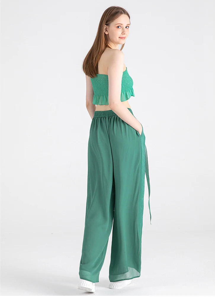 Side-back perspective of the Calm Jade silk trousers showing the relaxed fit and pocket detail — From Borcelleclothes.