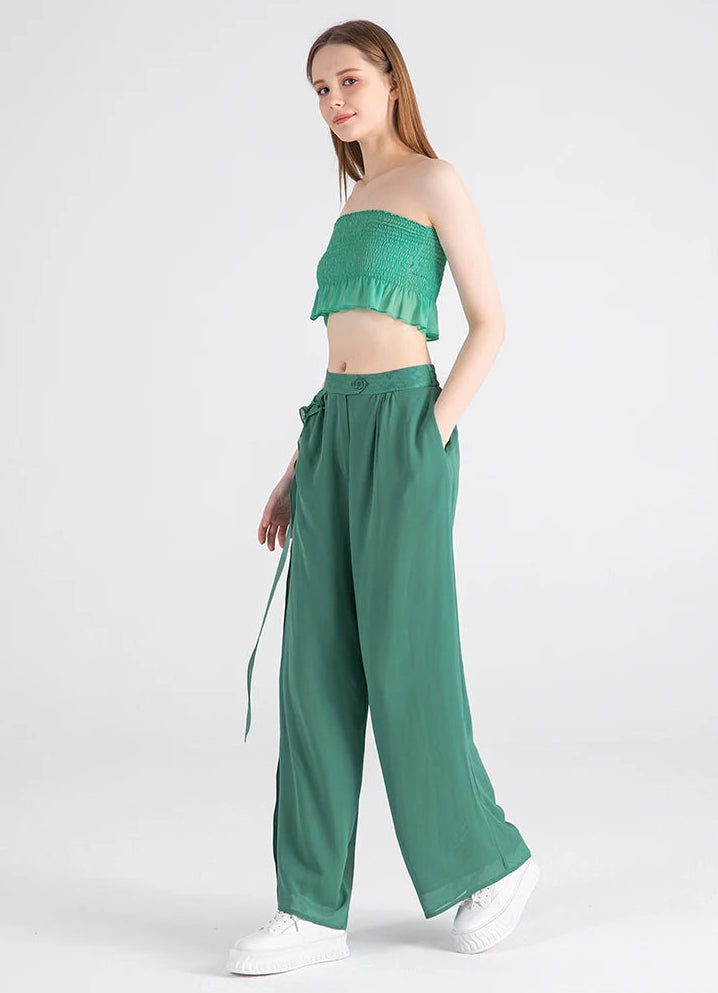Model with hand in the functional side seam pocket of the Calm Jade silk trousers — From Borcelleclothes.
