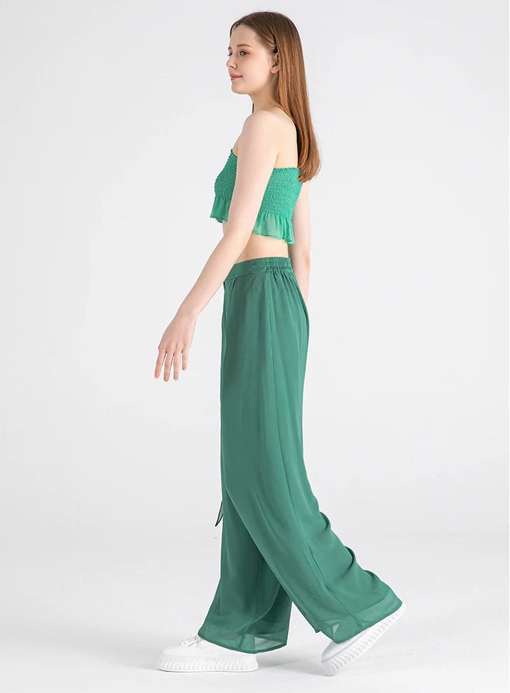 Side view of the model walking, highlighting the fluid georgette draping — From Borcelleclothes.