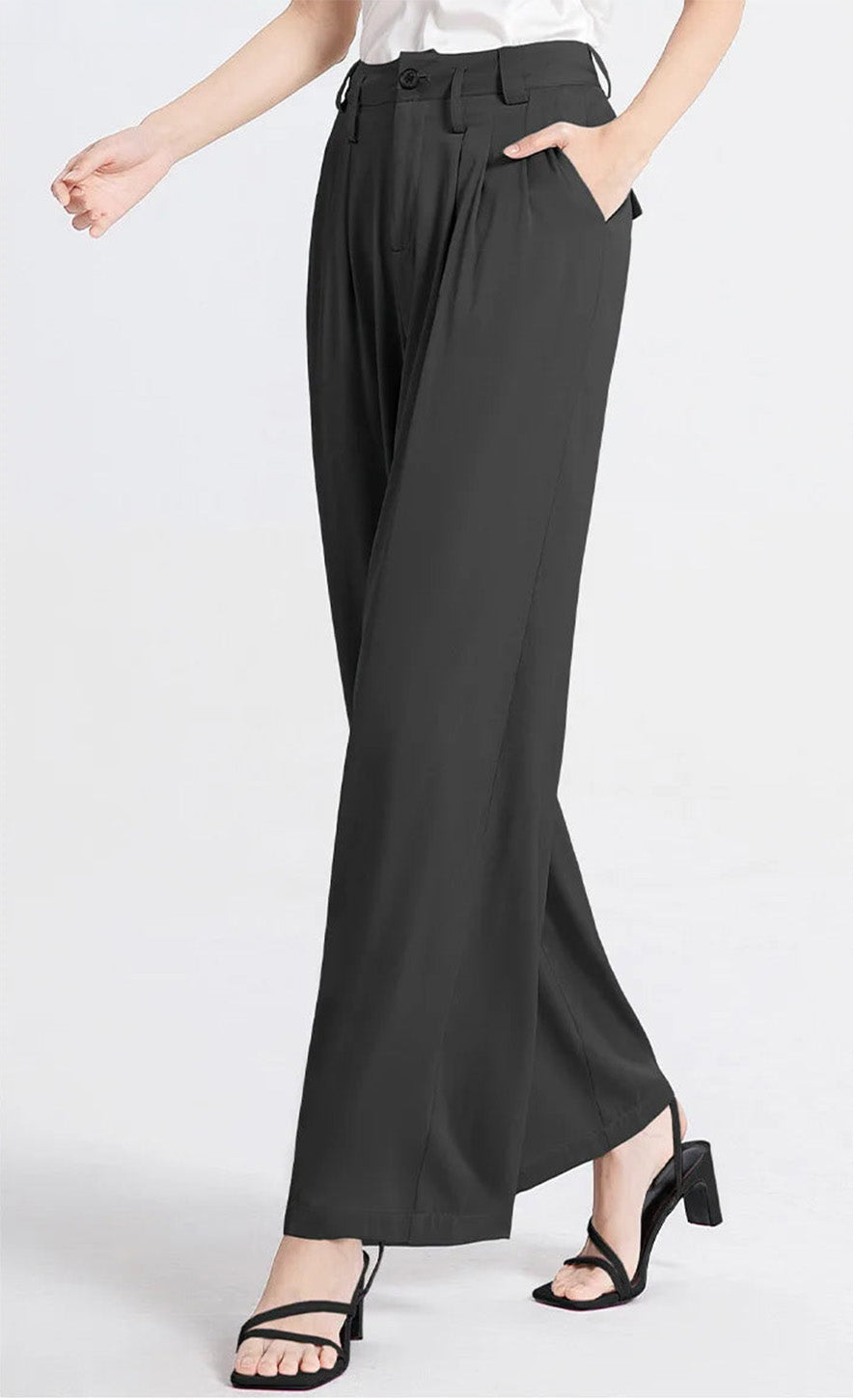 Side view of a model walking in dark Beyond Status silk wide-leg trousers. — Borcelleclothes.