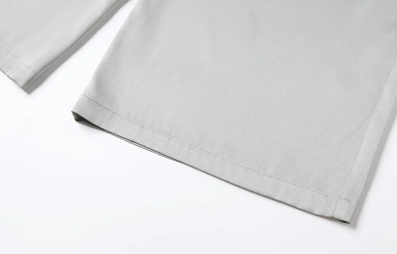 Close-up of the clean bottom hem and ankle length of gray silk trousers. — Borcelleclothes.