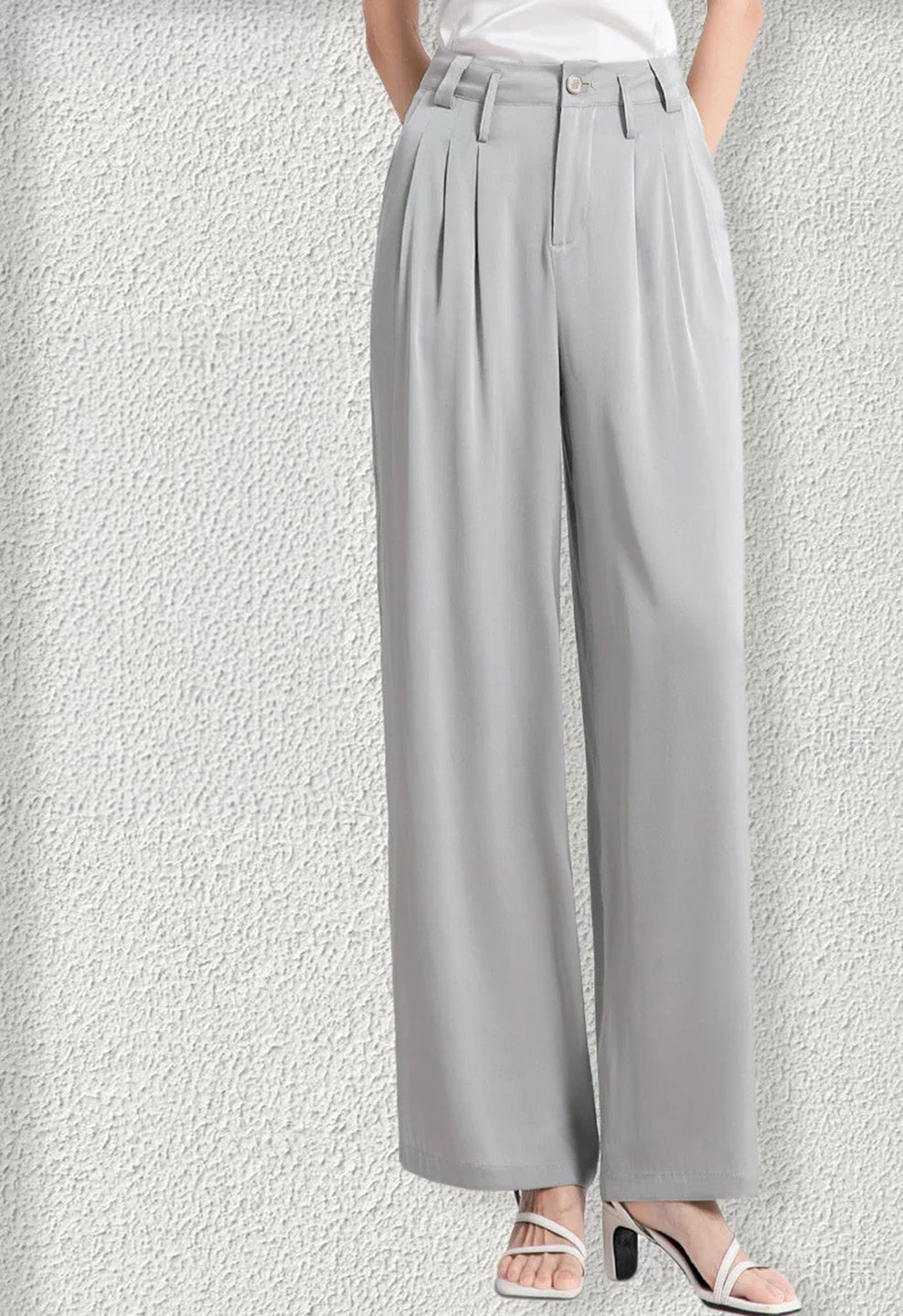 Side view focusing on the drape and foot placement in gray silk trousers. — Borcelleclothes.