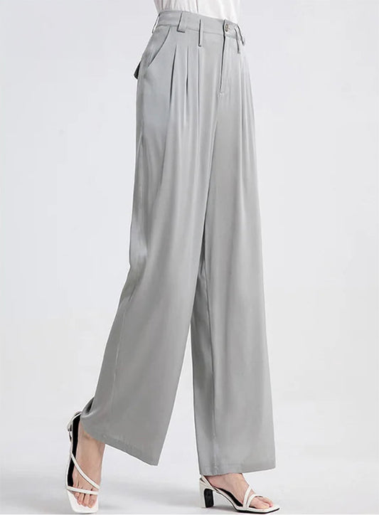 Model turned slightly to the side wearing gray Mulberry silk wide-leg trousers. — Borcelleclothes.