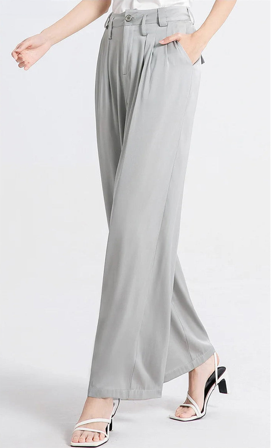 Side view of a model walking in flowing gray Mulberry silk trousers. — Borcelleclothes.