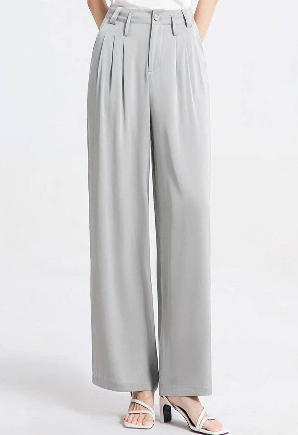 Model with hands behind her back wearing gray Mulberry silk trousers. — Borcelleclothes.