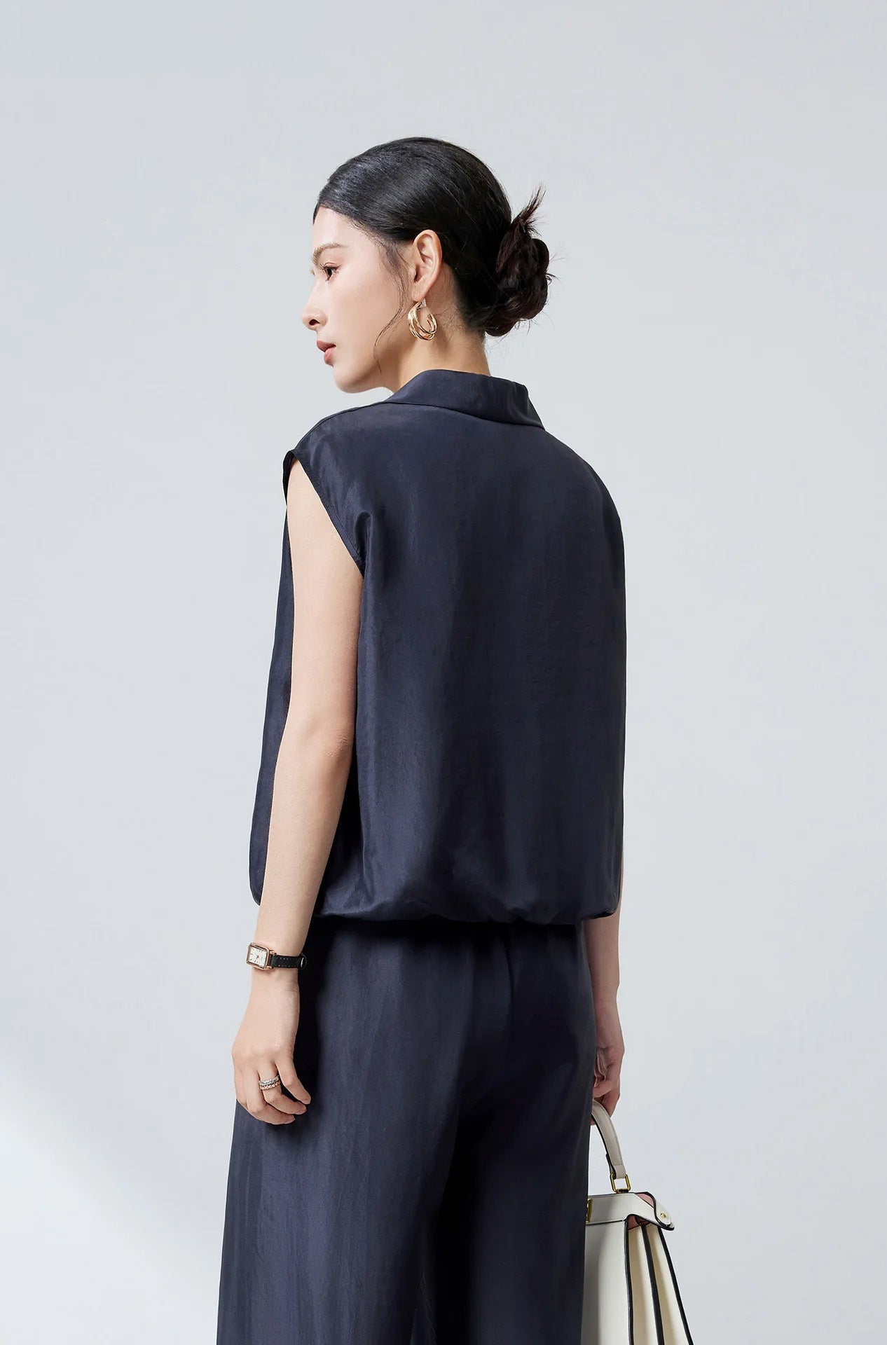 Rear view of model in Blueprint Mulberry silk layered blouson displaying fluid drape and clean finish — From Borcelleclothes.